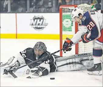  ?? [MARK J. TERRILL/THE ASSOCIATED PRESS] ?? Blue Jackets right wing Oliver Bjorkstran­d tries to get a shot past Kings goaltender Jonathan Quick during the first period Thursday night.