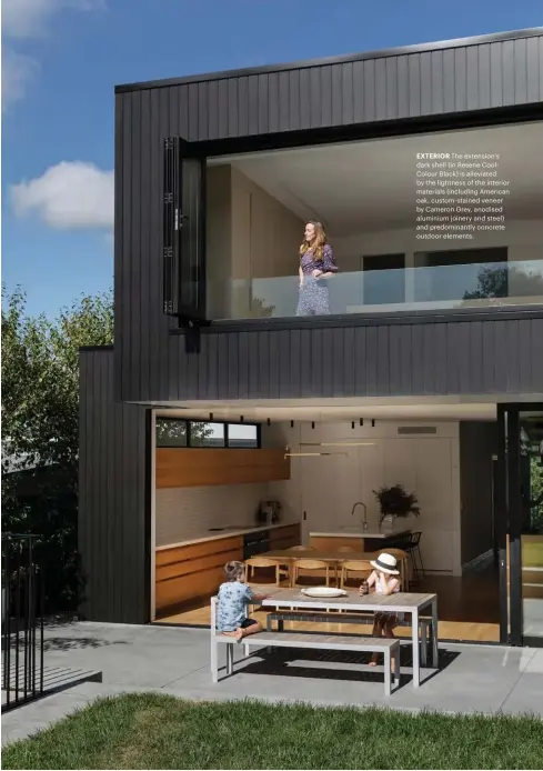  ??  ?? EXTERIOR The extension’s dark shell (in Resene CoolColour Black) is alleviated by the lightness of the interior materials (including American oak, custom-stained veneer by Cameron Grey, anodised aluminium joinery and steel) and predominan­tly concrete outdoor elements.