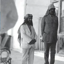  ??  ?? Sherif Hussein’s son Emir Abdullah (seated) with Colonel Cyril Wilson (third from left) at the British Consulate in Jeddah, 1916