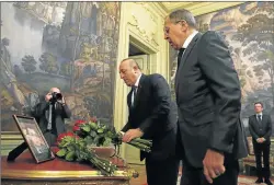  ?? Picture: REUTERS ?? SYMBOL OF RECONCILIA­TION: Russian Foreign Minister Sergei Lavrov, right, and his Turkish counterpar­t Mevlut Cavusoglu lay flowers in memory of the murdered Russian ambassador to Turkey, Andrei Karlov, before their talks in Moscow yesterday