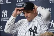  ?? MARY ALTAFFER — THE ASSOCIATED PRESS ?? New Yankees manager Aaron Boone puts on a Yankees hat during an introducto­ry news conference Wednesday at Yankee stadium in New York.