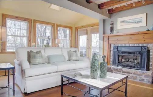  ?? PHOTOS: CHRIS MIKULA/OTTAWA CITIZEN ?? The family room of Stonestabl­es is part of an addition, but features such as exposed beams and the stone fireplace surround help it blend in with the original 1825 home.