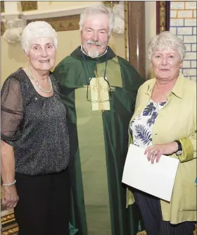  ??  ?? Monseignor Enda Lloyd celebratin­g 100 years of the Pioneer Associatio­n in the Parish with Sadie O’Shea and Mary Kelly.