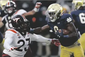  ?? ASSOCIATED PRESS ?? IN THIS NOV. 2, 2019, FILE PHOTO, Notre Dame running back Jafar Armstrong (8) stiff arms Virginia Tech linebacker Rayshard Ashby (23) during the second half of a game in South Bend, Ind.