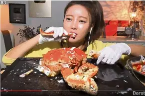  ??  ?? Excess consumptio­n: Most ‘mukbang’ fans like watching videos of people eating large portions of food as in this YouTube screencap.