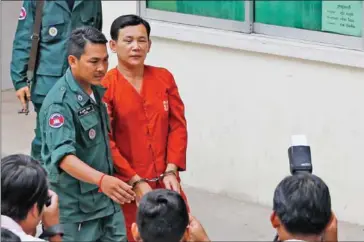  ?? PHA LINA ?? Seang Chet is escorted through the Phnom Penh Appeal Court grounds in July before a hearing.