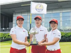  ?? ?? Japan players pose with the Queen Sirikit Cup trophy in Singapore yesterday.