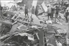  ?? FARAH ABDI WARSAMEH/AP ?? PEOPLE LOOK AT DESTROYED SHOPS in Mogadishu’s Lido beach, Somalia, on April 23 after a bomb blast by Somalia’s Islamic extremist rebels hit a popular seaside restaurant killing at least six people.