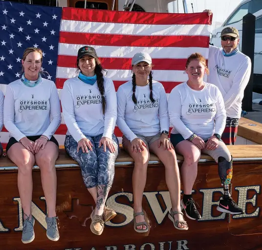  ??  ?? Stephanie Vazquez takes her turn at a sailfish with Sharon at her side (opposite). Sharon and Charles Miller hold the US flag behind Mea Peterson, Valarie Clark, Mallory Miller, Laly Cholak and Stephanie Vazquez.