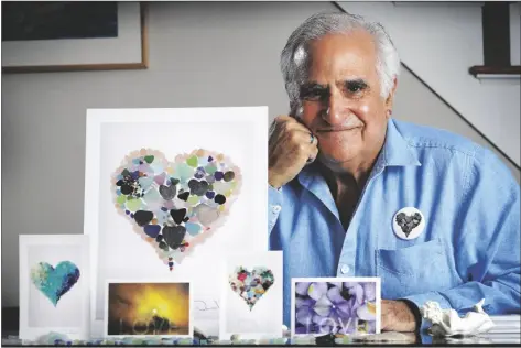  ?? ASSOCIATED PRESS ?? ARTIST DONALD VERGER POSES WITH HIS IMAGES of sea glass, landscapes and flowers on Thursday in Falmouth, Maine. Verger, who has donated his photograph­y to schools and hospitals, said he considers his small but colorful contributi­on a way of bringing a smile to people’s faces during the ongoing pandemic. “It seems like a great privilege to do something that supports happiness and some sense of hope,” said Verger.