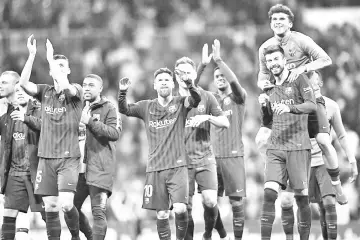  ??  ?? Barcelona players celebrate their win at the end of the Spanish league football match between Real Madrid CF and FC Barcelona at the Santiago Bernabeu stadium in Madrid on March 2, 2019. - AFP photo