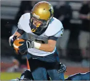  ?? MEDIANEWS GROUP FILE PHOTO ?? La Salle’s Jimmy Herron (3) crashes over North Penn defender James DiSimone (25) for a touchdown during first half action on Friday August 31,2012.