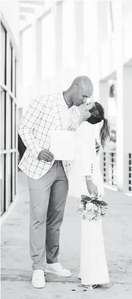  ?? COURTESY ?? Dolphins legend Jason Taylor with his wife, Monica, displaying their marriage license after they got married at a Plantation courthouse in August. Their planned 150-guest wedding was postponed numerous times because of COVID-19.