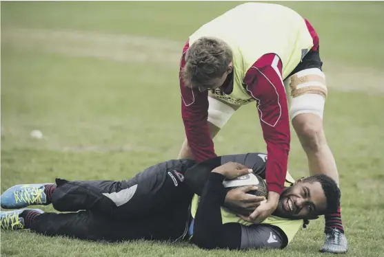  ??  ?? 2 Viliame Mata, who comes in at No 8 for Edinburgh against Glasgow this weekend, looks in good spirits as he clutches the ball during training at BT Murrayfiel­d.