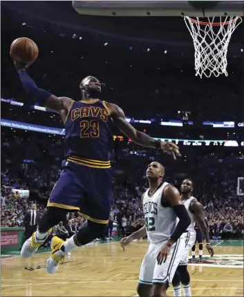  ??  ?? In this March 1 file photo, Cleveland Cavaliers forward LeBron James (left) lines up a dunk against Boston Celtics center Al Horford (right) during the third quarter of an NBA basketball game in Boston. AP PHOTO