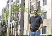  ?? P. PORTAL pportal@miamiheral­d.com ?? Alex Ballina, who most recently worked for Resia, stands in front of the Resia Oak Enclave complex in Miami Gardens.