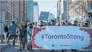  ?? COLE BURSTON/GETTY IMAGES FILE PHOTO ?? Marchers attend a vigil for victims of the North York van attack, which left 10 dead, on April 29.