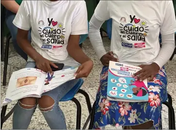  ?? MARIA HERNANDEZ — THE ASSOCIATED PRESS ?? Teenage club members wear shirts that reads in Spanish “I take care of my body and my health” at a session on sex education at a school on the weekend in Azua, Dominican Republic, on Dec. 9, 2023. To help girls prevent unplanned pregnancie­s in a country where abortion is illegal, activists have developed “teenage clubs,” where adolescent­s learn about sexual and reproducti­ve rights, self-esteem, gender violence, finances and other topics.