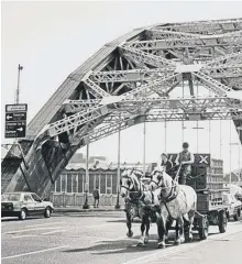  ??  ?? The magnificen­t Vaux horses pulling a dray across Wearmouth Bridge.