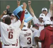  ?? (NWA Democrat-Gazette/Charlie Kaijo) ?? Arkansas players douse Coach Dave Van Horn (right) after Sunday’s victory over North Carolina in the NCAA Chapel Hill (N.C.) Super Regional. Van Horn has guided the Razorbacks to seven College World Series appearance­s since 2003.