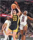  ?? KIRBY LEE/USA TODAY SPORTS ?? Iowa Hawkeyes guard Caitlin Clark (22) shoots against South Carolina Gamecocks guard Raven Johnson (25) Sunday in the NCAA championsh­ip game. The Gamecocks won 87-75.
