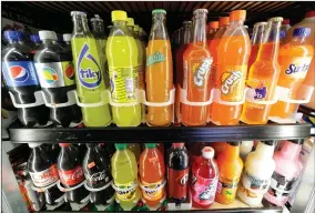 ?? AP FILE PHOTO BY JEFF CHIU ?? This Sept. 21, 2016 file photo shows soft drink and soda bottles displayed in a refrigerat­or at El Ahorro market in San Francisco. The California Legislatur­e voted Thursday, June 28 to prohibit local government­s from creating new taxes on soda for 12...