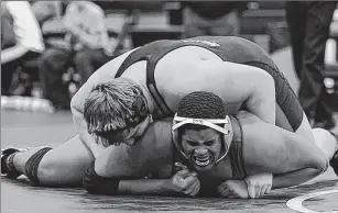  ?? MICHAEL MCLOONE / FOR THE JOURNAL SENTINEL ?? West Allis Central’s Laren Stradler grimaces underneath Muskego’s Jorin McGuire in the 285-pound match Saturday. McGuire won the regional title.