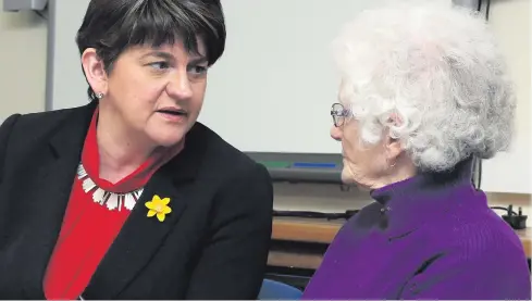  ??  ?? Arlene Foster speaks to pensioner Jean Ferguson at the Luncheon Club in Newbuildin­gs Community Centre at the weekend