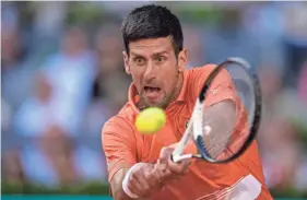  ?? MANU FERNANDEZ/AP ?? Novak Djokovic hits a return to Carlos Alcaraz during a semifinal at the Madrid Open on Saturday.