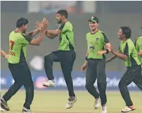  ?? Supplied photo ?? Lahore Qalandars’ youngsters celebrate the fall of a wicket against Multiply Titans at the Abu Dhabi T20 tournament. —