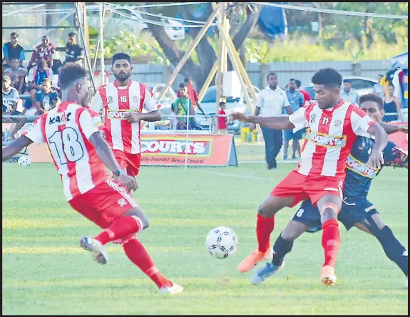  ?? Picture: REINAL CHAND ?? Labasa’s Atonio Tuivuna and Akeimi Ralulu work hard to stop Ba’s Darold Kakasi, right, during their match in the Courts Inter District Championsh­ip at Prince Charles Park in Nadi yesterday.