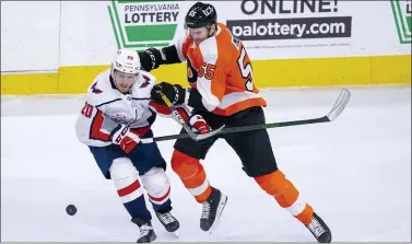  ?? CHRIS SZAGOLA — THE ASSOCIATED PRESS ?? The Flyers’ Samuel Morin, right, and Washington’s Lars Eller, left, battle for the puck during the third period on Saturday at the Wells Fargo Center. The Capitals won, 6-3.