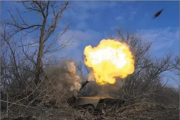  ?? Evgeniy Maloletka Associated Press ?? A UKRAINIAN self-propelled howitzer fires toward Russian forces near Bakhmut on Friday. Russia began the campaign to take control of the city in August. Both sides have experience­d staggering casualties there.