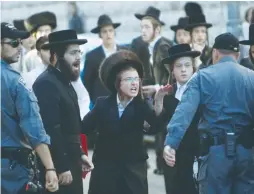  ?? (Baz Ratner/Reuters) ?? HAREDIM PROTEST in Jerusalem’s Mea She’arim neighborho­od against the municipali­ty’s opening of a nearby road on Shabbat.