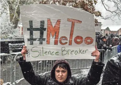  ?? PHOTOS BY GETTY IMAGES ?? People protest sexual harassment at a #MeToo rally outside Trump Internatio­nal Hotel on Dec. 9.