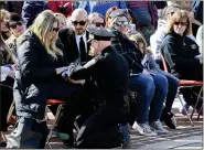  ??  ?? Berks County Sheriff Eric Weaknecht presents Alecia Pagerly Eberly with the flag for her late K-9 Jynx during services Monday.