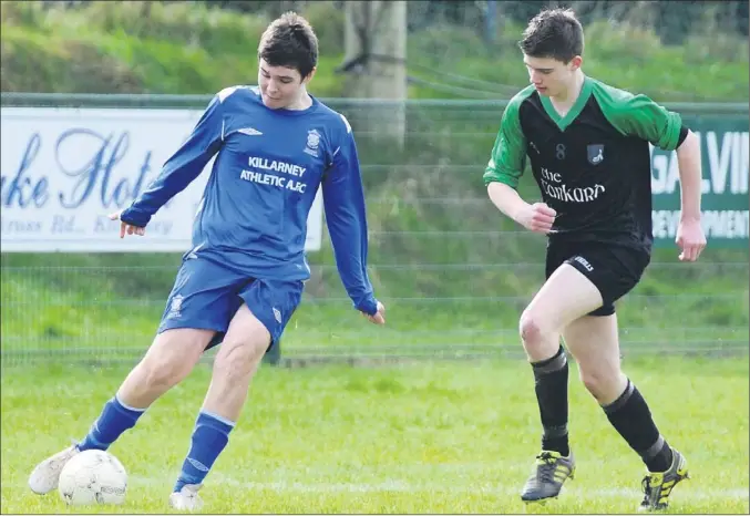  ?? PICTURE: MICHELLE COOPER GALVIN ?? Killarney Athletic's Cillain O'regan clears his backline ahead of Fenit's Ivan Parker in the Schoolboys League Under-16 Premier game in Killarney on Saturday.