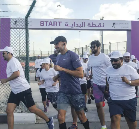  ?? Khushnum Bhandari for The National ?? Khaled Al Suwaidi sets off on a run with staff from Abu Dhabi Ports as a fund-raiser for his epic journey