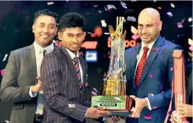  ??  ?? Kamindu Mendis from Richmond College, Galle, receiving the award for Schoolboy Cricketer of the Year 2018 from Graeme Labrooy - Former National Cricketer and Present Chairman, Selection Committee, Sri Lanka Cricket who graced the awards ceremony as the Chief Guest. Also in picture is Harsha Samaranaya­ke - General Manager, Brand and Media, Dialog Axiata PLC