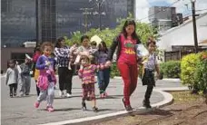  ?? AFP ?? Top and above: Immigrants wait to head to a nearby Catholic Charities relief centre after being dropped off at a bus station shortly after release from detention through ‘catch and release’ immigratio­n policy on Sunday in McAllen, Texas.