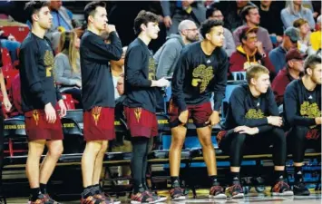  ?? AP PHOTO/MATT YORK ?? Arizona State players watch from the bench during the first half against Washington State on Thursday in Tempe, Ariz. The players at the end of the bench watch the score running up and the clock winding down, wondering when it will be their turn to finally get a chance to play.