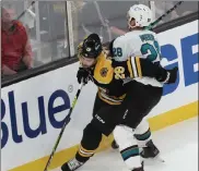  ?? Nancy lane / boston Herald ?? bruins defenseman derek Forbort battles for the puck with san Jose sharks wing timo meier on sunday at the Garden.