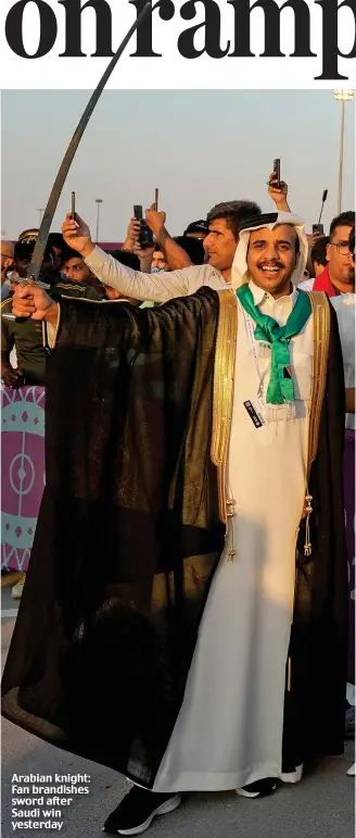  ?? ?? Arabian knight: Fan brandishes sword after Saudi win yesterday