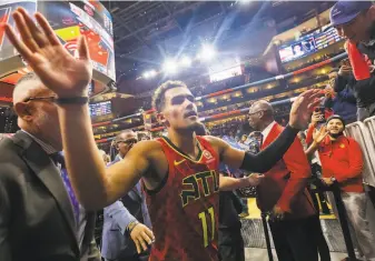  ?? Carmen Mandato / Getty Images ?? Atlanta’s Trae Young heads off the court following his team’s win over visiting Orlando on Saturday. The point guard is averaging 38.5 points and nine assists through two games.