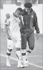  ?? Frederick Breedon Getty Images ?? FREDDY ADU, left, leaves the field in Nashville after the U.S. failed to qualify for the Olympics.