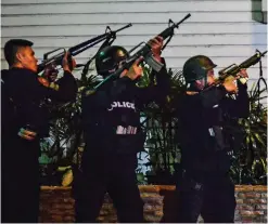  ??  ?? Fighting back: Police marksmen in Manila yesterday