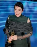  ??  ?? Olivia Colman accepts the award for best performanc­e by an actress in a leading role for The Favourite at the Oscars.