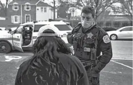  ?? E. JASON WAMBSGANS/CHICAGO TRIBUNE ?? Police officers assist a young woman who had her car taken at gunpoint while picking up her baby from a day care center in the South Deering neighborho­od on March 12.