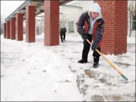  ?? Hearst Connecticu­t Media file photo ?? Max Moura, foreground, and Mark Volza clear the sidewalk at McKinley School in Fairfield on Jan. 18, 2011. The state Department of Education has been authorized to develop guidelines for districts to use remote learning for all on inclement weather days.