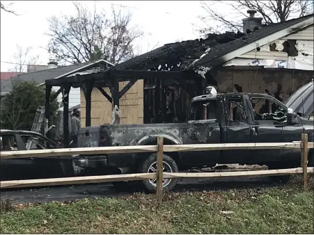  ?? STEVEN HENSHAW — MEDIANEWS GROUP ?? A family was homeless Dec. 2 after flames gutted their house along Perry Road in Perry Township. The fire also destroyed vehicles next to the house. The resident and his two children escaped the fire without injury, officials said.